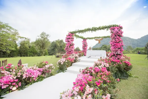 Outdoor altar framed by pink flowers